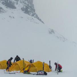 Members of the Antarctic Heritage Trust Inspiring Explorers Expedition™ pitching their tents in snowy conditions during their ski crossing of South Georgia