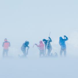 Snow engulfs Inspiring Explorers as they prepare to ski downhill in a snow storm on their South Georgia crossing