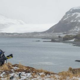 Inspiring Explorer James Blake looking across a bay to a glacier