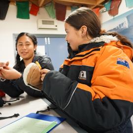 Young Inspiring Explorers Vivian and Kahlen trying on gear at Antarctica New Zealand