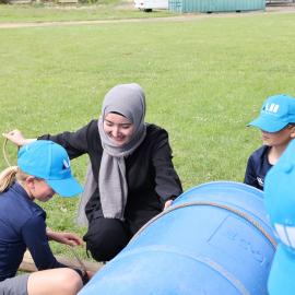 Inspiring Explorer Sadra Sultani assisting students with raft building