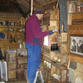 2005 Doug Rogan inventorying artefacts inside Shackleton's 'Nimrod' hut