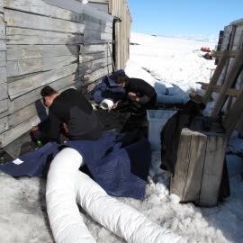 2009-10 AHT's Fran Clarke and Lizzie Meek excavating coal briquettes, Scott's 'Terra Nova' hut