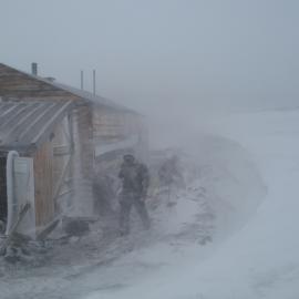 K170 team in a storm, Scott's 'Terra Nova' Hut 