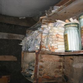 2003-04 Candles stored on Venesta box shelves in darkroom in Shackleton's 'Nimrod' Hut (001)