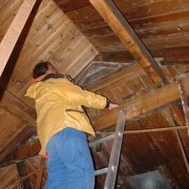 2003-04 Arrow International's Noel Saxon assessing the rafters in Shackleton's 'Nimrod' Hut 
