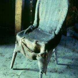 Wooden framed chair with improvised sacking cover, messdeck