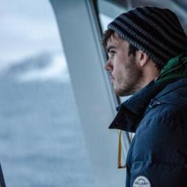 Alexander Hillary gazing out 'Navigator' at Antarctic Peninsula scenery