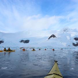 Inspiring Explorers kayaking in a convoy through brash ice