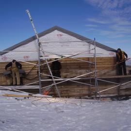 Heritage Carpenters re-installing cladding, east elevation