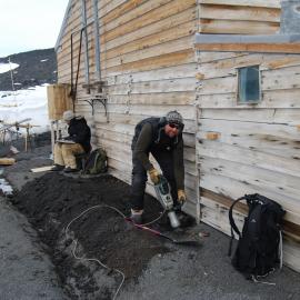 Prepping for installing waterproof membrane, east wall of Scott's 'Terra Nova' Hut 