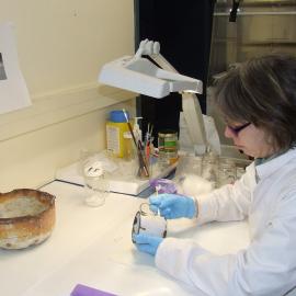 2007 Conservator Fiona Cahill treating an enamel mug