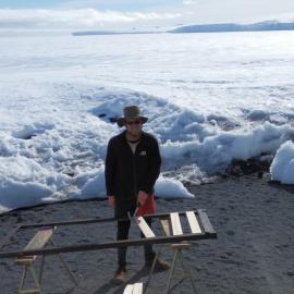John Evans repairing bed frame, Cape Evans