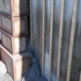 Scoria in-fill behind boxes, Shackleton's 'Nimrod' Hut