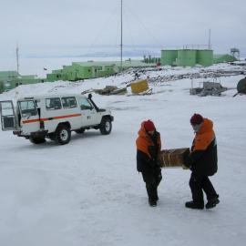 2013-14 Lizzie Meek and Josiah Wagener carry artefacts from a truck, Scott Base (002)