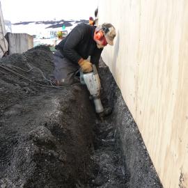 2009-10 AHT's Al Fastier digging trench along Stables exterior, Scott's 'Terra Nova' hut