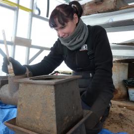2009-10 AHT's Fran Clarke treating Stables blubber stove, Cape Evans