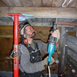 2009-10 AHT's Gord Macdonald working inside Stables, Scott's 'Terra Nova' hut