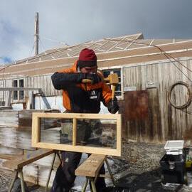 2009-10 AHT's Martin Wenzel working outside Shackleton's 'Nimrod' hut, Cape Royds
