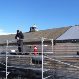 2010-11 John Taylor on scaffolding, Cape Evans