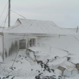 Snow build-up, northeast elevation of Shackleton's 'Nimrod' hut