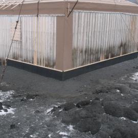Fixed Butynol valance at base of southeast corner, Shackleton's 'Nimrod' hut