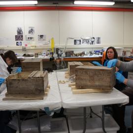 2012 AHT conservators treating excavated alcohol crates, Scott Base