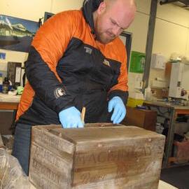 2012 AHT's Stefan Strittmatter treating whisky crate, Scott Base