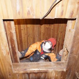 2015-16 Lizzie Meek in roof cavity, Borchgrevink's hut