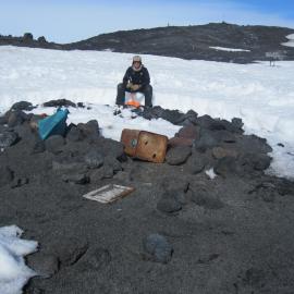 2010-11 Jamie Clarke with the Stone Hut at Cape Evans