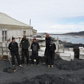 2022-23 Conservation team outside Shackleton's 'Nimrod' hut, Cape Royds