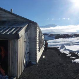Inspecting exterior, Scott's 'Terra Nova' hut