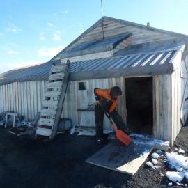 Removing snow from entrance, Scott's 'Terra Nova' hut 