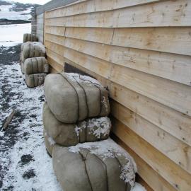 2010-11 Fodder bales stacked outside the Stables, Cape Evans
