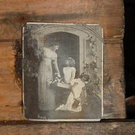 2010-11 Image of a woman with two children inside Scott's 'Terra Nova' hut