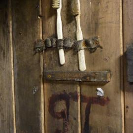 2010-11 Toothbrushes mounted above Griffith Taylor's bunk, Cape Evans