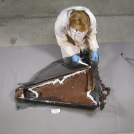 AHT Conservator Julie Unruh cutting away working on dredge (001)