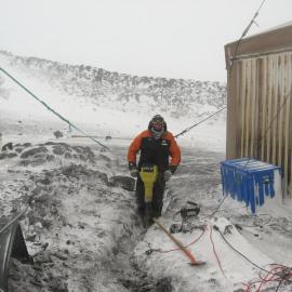 2010-11 John Taylor digging a trench outside Shackleton's 'Nimrod' hut