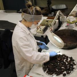 2014 AHT winter conservators at work - Stefanie White treating pan with seal meat (001)