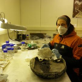 2014 AHT's Meg Absolon with Nansen cooker part, winter conservation lab, Scott Base