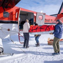 ALE staff load the Inspiring Explorer team's equipment into a plane