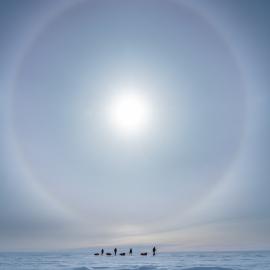 Inspiring Explorers Expedition™ team below a sun dog on the South Pole Expedition