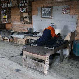 2018-19 Nicola Stewart vacuuming inside Shackleton's 'Nimrod' hut, Cape Royds