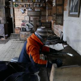 2018-19 Nicola Stewart vacuuming inside Shackleton's 'Nimrod' hut, Cape Royds