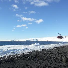 Helicopter arriving at Cape Evans