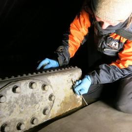2013-14 Conservators at work. Nicola Dunn treating the water tank, Cape Evans (003)