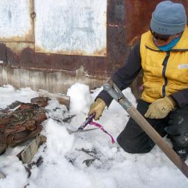 Heritage Carpenter Ted Bugg extracting a box from snow and ice