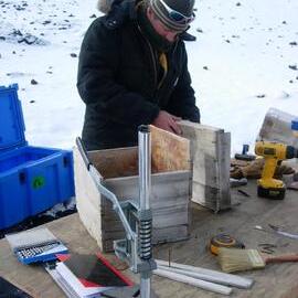 Heritage Carpenter Bryce Lewis repairing boxes from stables wall