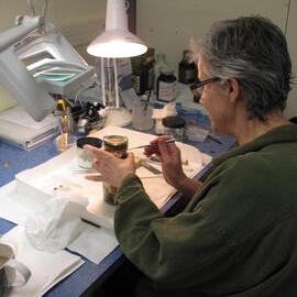 AHT Conservator Therese Charbonneau treating a bottle of pickles