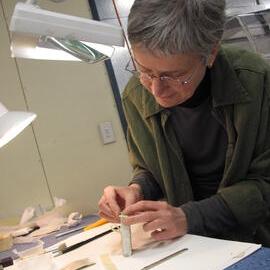 AHT Conservator Therese Charbonneau treating a cardboard box